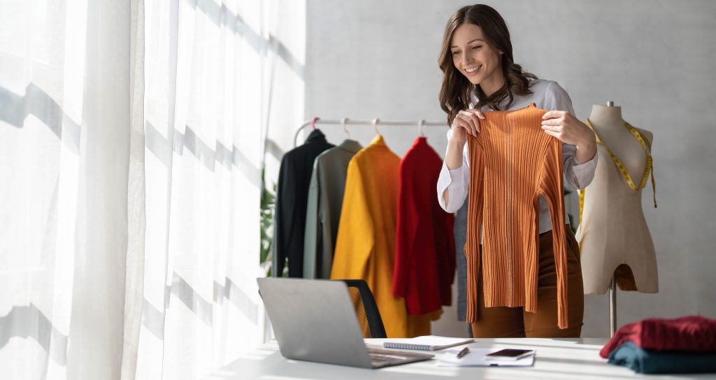 woman-holding-up-clothed-to-show-the-computer